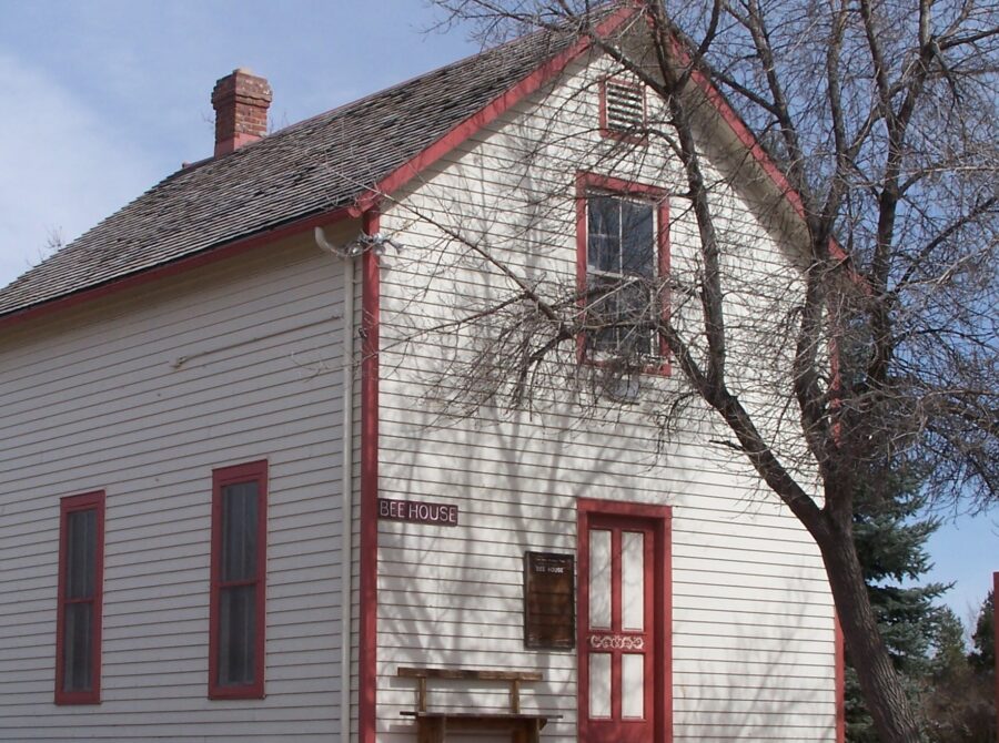 Two-story house labeled "Bee House" with red trim.