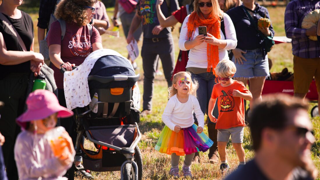 Children with face paint and Halloween clothes at outdoor event