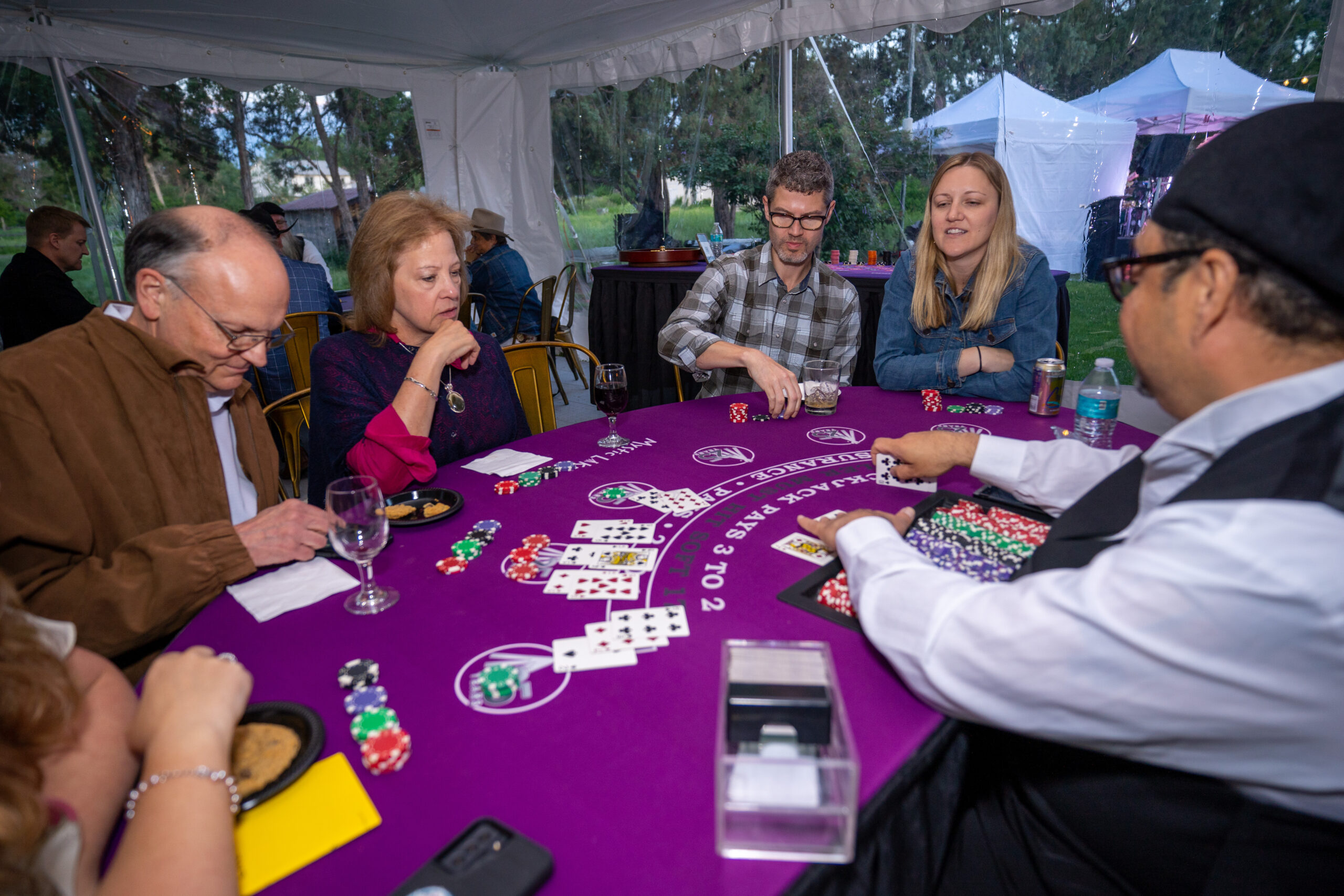 People playing cards at a gala event.