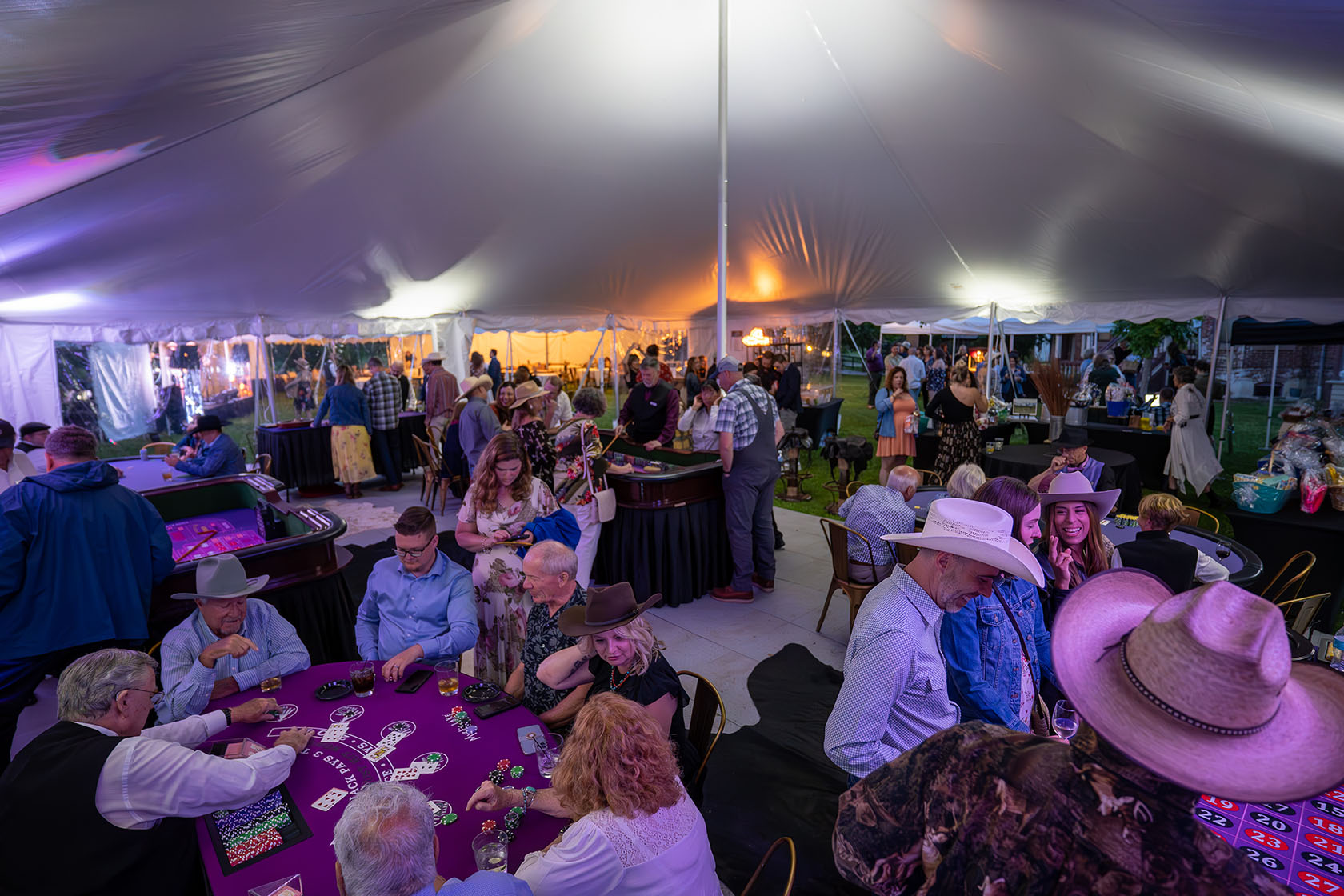 People at a gala event under a large tent