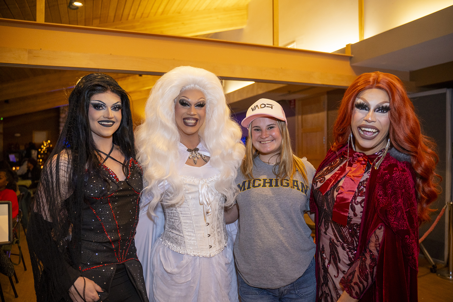 Group of four people, one wearing a Michigan shirt